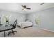 Neutral bedroom with a ceiling fan, large windows, desk, and comfortable bed creates a serene space at 7039 Old 421 Rd, Liberty, NC 27298
