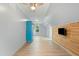 Spacious bonus room with wood floors, natural light, and a wood accent wall, perfect for flexible living at 7039 Old 421 Rd, Liberty, NC 27298