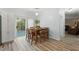 Cozy dining area with wood table, seating for six, and sliding glass doors to outdoor living at 7039 Old 421 Rd, Liberty, NC 27298