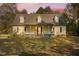 Two-story home with front porch and autumn landscaping at 7039 Old 421 Rd, Liberty, NC 27298