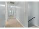 Hallway that provides access to a second level and leads to the home's bedrooms and shared living spaces at 7039 Old 421 Rd, Liberty, NC 27298