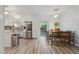 Bright eat-in kitchen with stainless steel appliances, white cabinetry, and wood-look flooring at 7039 Old 421 Rd, Liberty, NC 27298