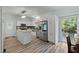 Eat-in kitchen featuring an island and access to a backyard patio at 7039 Old 421 Rd, Liberty, NC 27298