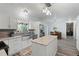 Open kitchen and dining area with granite countertops, stainless appliances, and hardwood floors at 7039 Old 421 Rd, Liberty, NC 27298