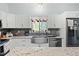 Updated kitchen with stainless steel appliances, island, granite countertops, and tiled backsplash at 7039 Old 421 Rd, Liberty, NC 27298