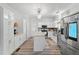 Bright kitchen with white cabinets, stainless appliances, island, and hardwood flooring at 7039 Old 421 Rd, Liberty, NC 27298