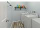 Clean laundry room with modern washer and dryer, featuring built-in shelving and storage at 7039 Old 421 Rd, Liberty, NC 27298