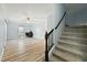 Open-concept living room with hardwood floors, a ceiling fan, and natural light at 7039 Old 421 Rd, Liberty, NC 27298
