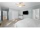 Bright main bedroom featuring a ceiling fan, soft carpet, with an ensuite bathroom, and walk-in closet at 7039 Old 421 Rd, Liberty, NC 27298