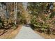 Gravel path through a wooded area, surrounded by mature trees, perfect for a nature walk at 7039 Old 421 Rd, Liberty, NC 27298