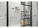 Stylish bathroom shower with sleek black hardware, marble tile, built in shelves and a modern glass door at 7039 Old 421 Rd, Liberty, NC 27298