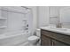 Well-lit bathroom featuring a shower-tub combo, a modern vanity, and neutral finishes at 7529 Percussion Dr, Apex, NC 27539
