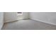 Neutral-toned bedroom with carpet flooring, white trim, and a window bringing in natural light at 7529 Percussion Dr, Apex, NC 27539