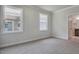 Bedroom featuring dual windows with view of home exterior and bathroom doorway at 7529 Percussion Dr, Apex, NC 27539