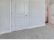 Cozy bedroom with soft carpet, white trim, and a closet, creating a comfortable and inviting space at 7529 Percussion Dr, Apex, NC 27539