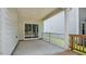 Covered patio offers a seamless indoor-outdoor transition with sliding glass doors and railing at 7529 Percussion Dr, Apex, NC 27539