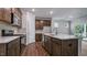 Modern kitchen with stainless steel appliances, a large island with a sink, and plenty of cabinet space at 7529 Percussion Dr, Apex, NC 27539