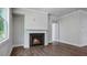 Spacious living room with luxury vinyl plank flooring and a traditional fireplace at 7529 Percussion Dr, Apex, NC 27539