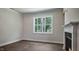 Neutral living area with a traditional fireplace and large window providing natural light at 7529 Percussion Dr, Apex, NC 27539