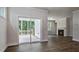 Open living area with luxury vinyl plank flooring, fireplace, and sliding doors to the back patio at 7529 Percussion Dr, Apex, NC 27539