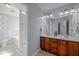 Bathroom with a double sink vanity and an open doorway to the toilet and tub at 1120 Renewal Place # 108, Raleigh, NC 27603