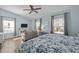 Inviting bedroom featuring a large bed, multiple windows, and a gray couch at 1120 Renewal Place # 108, Raleigh, NC 27603