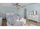 Bright bedroom boasts blue walls, white furniture, and a sitting area at 1120 Renewal Place # 108, Raleigh, NC 27603