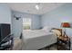 Serene bedroom with light blue walls, a comfortable bed, and a window offering natural light at 1120 Renewal Place # 108, Raleigh, NC 27603