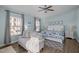 Cozy bedroom with a ceiling fan, love seat, and white bedroom set at 1120 Renewal Place # 108, Raleigh, NC 27603