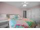 Bright bedroom with a colorful quilt, hardwood floors and ample closet space for storage at 1120 Renewal Place # 108, Raleigh, NC 27603