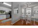 Dining room with stainless steel appliances, white cabinets, and hardwood floors, adjacent to a cozy eating area at 1120 Renewal Place # 108, Raleigh, NC 27603
