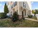 Exterior of a tan house with a front lawn and black shutters at 1120 Renewal Place # 108, Raleigh, NC 27603