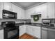 Updated kitchen with white cabinets, modern appliances, and dark countertops at 1120 Renewal Place # 108, Raleigh, NC 27603