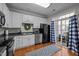 Bright kitchen features white cabinets, modern appliances, and sliding glass doors to the patio at 1120 Renewal Place # 108, Raleigh, NC 27603