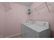 Functional laundry room equipped with a washing machine, dryer, and shelving units for storage at 1120 Renewal Place # 108, Raleigh, NC 27603