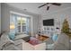 Bright living room featuring a sectional sofa, a glass coffee table, and a large window with floral drapes at 1120 Renewal Place # 108, Raleigh, NC 27603