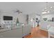 Comfortable living room with wood floors, a large sectional sofa, and views of the staircase and kitchen at 1120 Renewal Place # 108, Raleigh, NC 27603