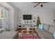 Cozy living room with hardwood floors, a comfortable grey sectional sofa, and modern decor at 1120 Renewal Place # 108, Raleigh, NC 27603