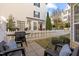 Enclosed back patio with a grill, seating, and manicured landscaping at 1120 Renewal Place # 108, Raleigh, NC 27603
