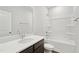 Well-lit bathroom with a single sink, modern fixtures, and shower-tub combo at 1204 Holding Village Way, Wake Forest, NC 27587