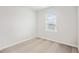 A simple, carpeted bedroom with a large window and white trim at 1204 Holding Village Way, Wake Forest, NC 27587