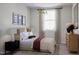 Stylish bedroom featuring a modern chandelier, large window, and neutral decor at 1204 Holding Village Way, Wake Forest, NC 27587