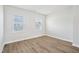 Bright bedroom with laminate flooring and two windows, offering ample natural light and a modern aesthetic at 1204 Holding Village Way, Wake Forest, NC 27587