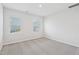 Bright, carpeted bedroom with two windows and neutral color palette at 1204 Holding Village Way, Wake Forest, NC 27587
