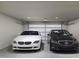 Spacious two car garage with a white BMW and a black Mercedes-Benz parked in the large and clean space at 1204 Holding Village Way, Wake Forest, NC 27587