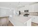 Bright kitchen features a large island with stone countertops and stainless steel appliances at 1204 Holding Village Way, Wake Forest, NC 27587