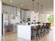 Spacious island kitchen with pendant lighting, stainless steel appliances, and gray cabinetry at 1204 Holding Village Way, Wake Forest, NC 27587