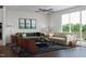 Bright living room featuring hardwood floors, modern furniture, and a large balcony at 1204 Holding Village Way, Wake Forest, NC 27587