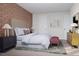 Bedroom featuring a decorative accent wall, large window and furniture at 1204 Holding Village Way, Wake Forest, NC 27587
