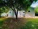 Home's rear exterior featuring brick pathway, private entrance, and ample outdoor living space at 135 Weatherbend, Pittsboro, NC 27312